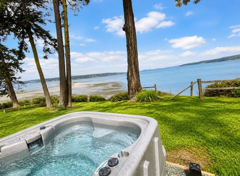Hot Tub Retreat: Immerse yourself in bubbles while soaking up stunning waterfront views!