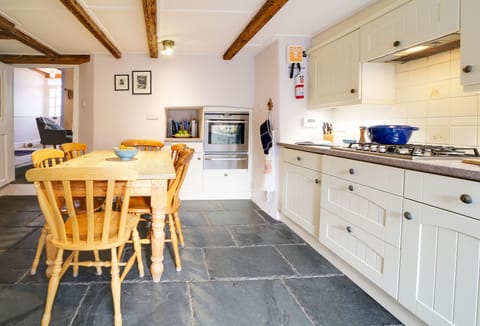 Hardys, Padstow. Ground Floor: Kitchen with an electric oven, gas hob, microwave, fridge, dishwasher, and Nespresso coffee machine