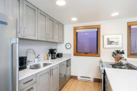 Kitchen looks out to the living room and dining
