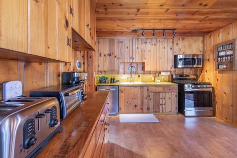 Enjoy the rustic mountain kitchen, where warm wood surrounds you and modern appliances make cooking a joy.