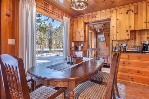 The wooden dining table provides ample seating for friends and family to gather around for a home cooked meal.