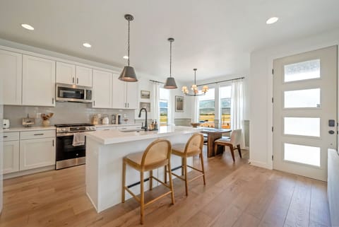 The kitchen at Hygge Ridge is well stocked with all of the amenities and tools a chef needs to cook meals for a group.  The dining table seats 6 and there are 2 additional bar seats at the island