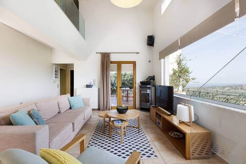 The Aegean Sea view is visible from some parts of the living room.