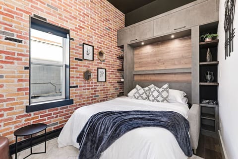 A bright and cozy studio with 12-foot ceilings and a comfortable queen Murphy bed that folds away to open up the space during the day.