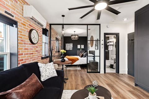 Welcome to The Foundry - an industrial-modern suite with warm brick, glass accents, and a cozy layout designed for a comfortable stay.