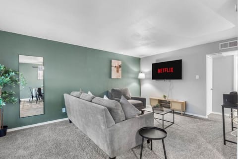 Spacious and inviting living area with comfortable seating and a smart TV, perfect for relaxing after exploring Arlington or attending events at AT&T Stadium.