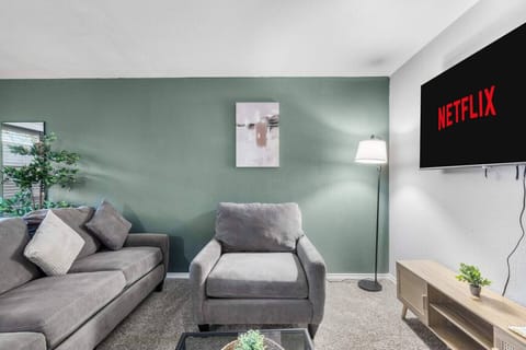 Spacious and inviting living area with comfortable seating and a smart TV, perfect for relaxing after exploring Arlington or attending events at AT&T Stadium.