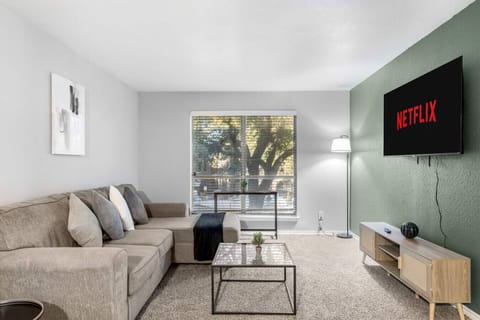 Spacious and inviting living area with comfortable seating and a smart TV, perfect for relaxing after exploring Arlington or attending events at AT&T Stadium.