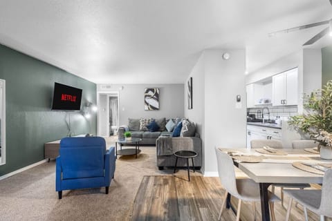 Spacious and inviting living area with comfortable seating and a smart TV, perfect for relaxing after exploring Arlington or attending events at AT&T Stadium.
