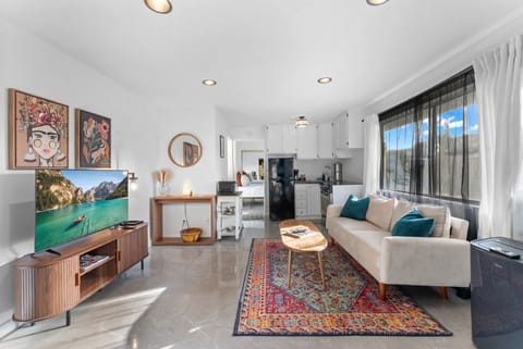 Bright, open living space with cozy vibes and pops of color.