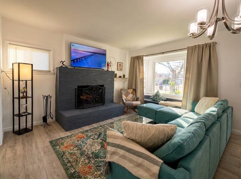 Bright living room with fireplace, Smart TV, and comfortable seating