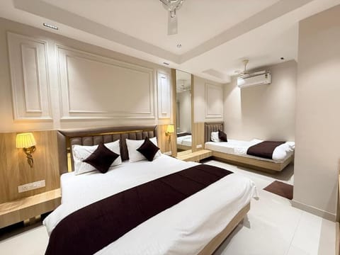 Deluxe Triple Room, City View | In-room safe, desk, laptop workspace, blackout drapes