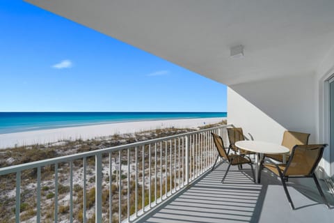 Relax with morning coffee while watching dolphins and waves from the private balcony at Cabana Club 203.
