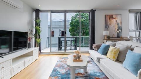 Comfortable lounge with smart TV and balcony access