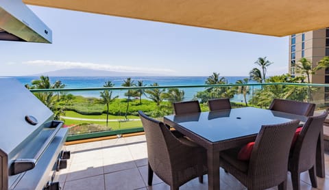 Covered balcony with dining table and panoramic ocean views, perfect for meals in the breeze.


 HKK-450