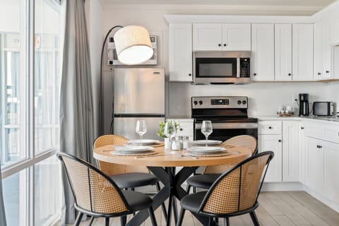 Enjoy meals together at the dining table with a full kitchen designed for comfortable, longer stays.