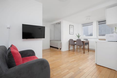 Living room with sofa and open kitchen layout.