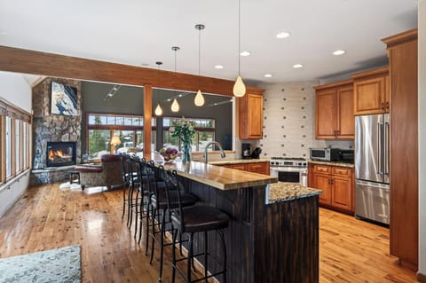 Side view of the kitchen showing the granite countertops and wood cabinetry.