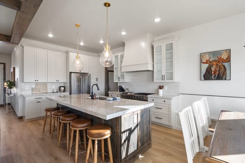 The chefs kitchen is well appointed with high end professional appliances, beautiful custom granite counter tops a built in dining table and bar seating for 5 and a large butlers pantry with wine fridge, extra preparation surface and numerous countertop appliances
