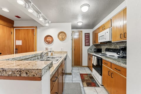 Your fully equipped kitchen features granite countertops, stainless appliances, and warm wood cabinets for memorable meal preparation.