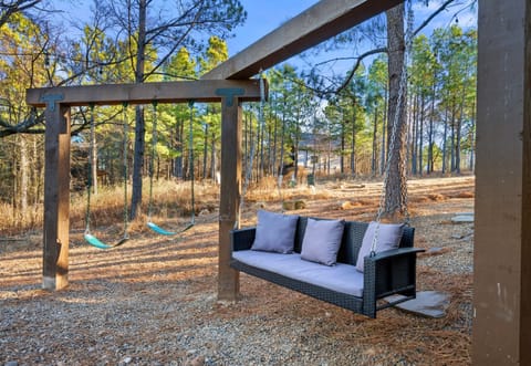 This outdoor lounge space is a great place to sit, relax, and enjoy the wooded surroundings while the kids play or the grill heats up.