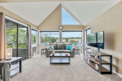 The magnificent windows allow the sun to shine into this spacious living room.
