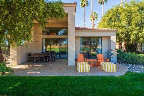 Relaxing back area with table, chairs, seating and BBQ