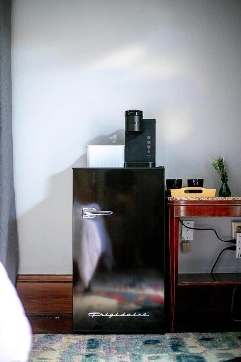 Mini fridge with a coffee maker.