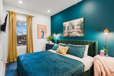 This vibrant teal bedroom blends professional utility with a high-end boutique hotel feel.