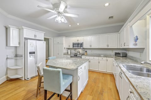 Sip your morning coffee at the central island before heading to the beach.