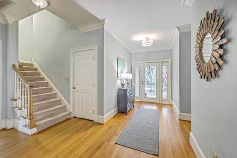 Step into serenity. This bright, airy foyer welcomes you with warm hardwoods and a touch of coastal elegance.