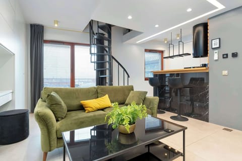 Relax in the stylish living room with a comfortable sofa and modern decor.