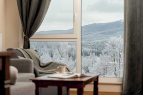 Picturesque view from the window overlooking rolling mountains and peaceful natural scenery.