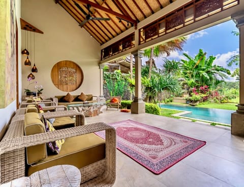 Open living space with bespoke furnishings and seamless pool views