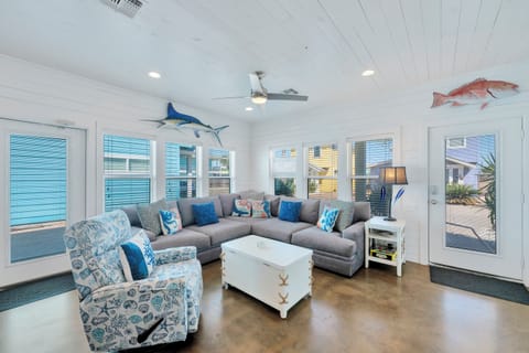 Relax in your coastal living room with nautical decor, comfy sectional seating, and ocean-themed touches creating the perfect beach house atmosphere.