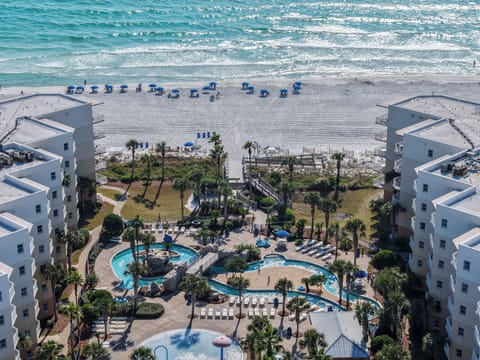 Feel your toes sink into soft white sand as emerald waves roll beside the resort