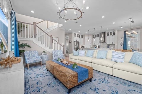 Designer living room featuring custom artwork, premium furnishings, and airy open floor plan.