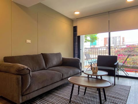 Cozy living room with modern décor and natural light — perfect to relax after a long day.