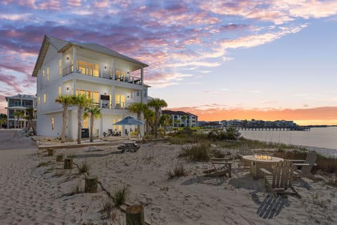Three stories of porches over the Sound, sunset, and a fire pit on the sand