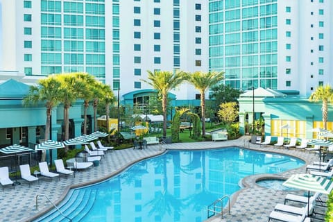 Soak up sunshine beside the sprawling palm-lined pool deck.