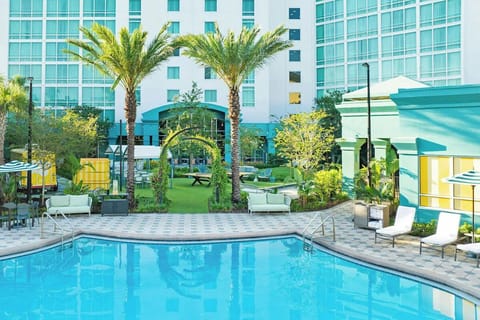 Sip and stroll through tropical greenery beside the refreshing pool.
