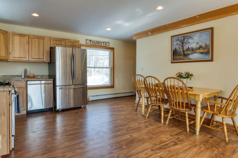 Modern kitchen area with stainless steel appliances and a breakfast table