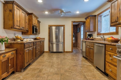 Wide kitchen view with island counter and modern appliances.