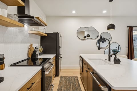 Kitchen: Cook, snack, and gather in this sleek modern kitchen—fully equipped and ready for big-group meals and unforgettable moments.