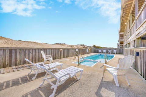 Your private pool oasis awaits with comfortable loungers and peaceful dune views for ultimate relaxation.