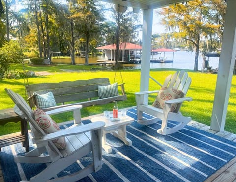 Chill on the covered porch on rocking chairs and porch swing.