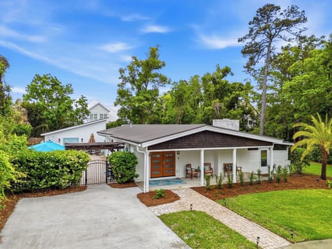 Front Exterior with Driveway Parking - Covered front porch, landscaped yard, and driveway parking at 530 Delegal on the South End of St. Simons.