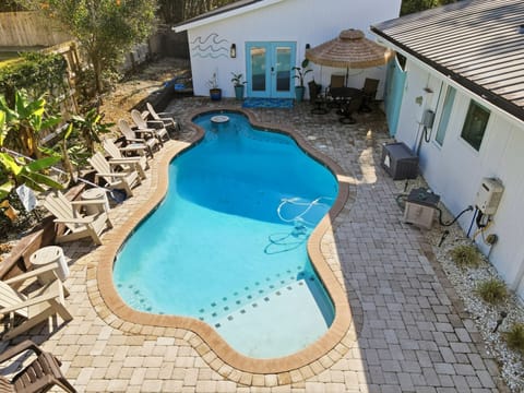 Courtyard Pool and Lounge Seating – 530 Delegal - Overhead view of the heated pool at 530 Delegal showing paver deck, multiple lounge chairs, and the surrounding gated courtyard adjacent to the guest house.