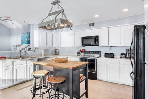 The fully equipped kitchen features granite countertops, stainless steel appliances, and a charming island where you can prep meals or enjoy casual dining.