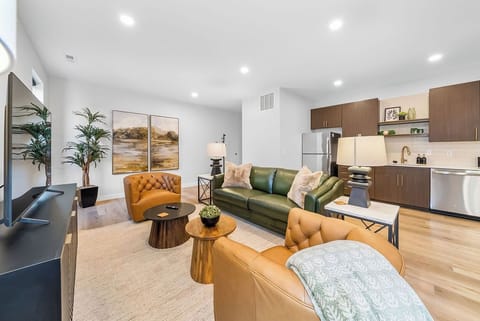 Unwind in this stylish open-concept space where leather seating meets modern kitchen convenience, perfect for your relaxing getaway.